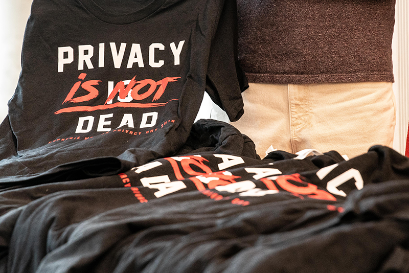 Privacy day featuring image of black and red privacy shirts on a table
